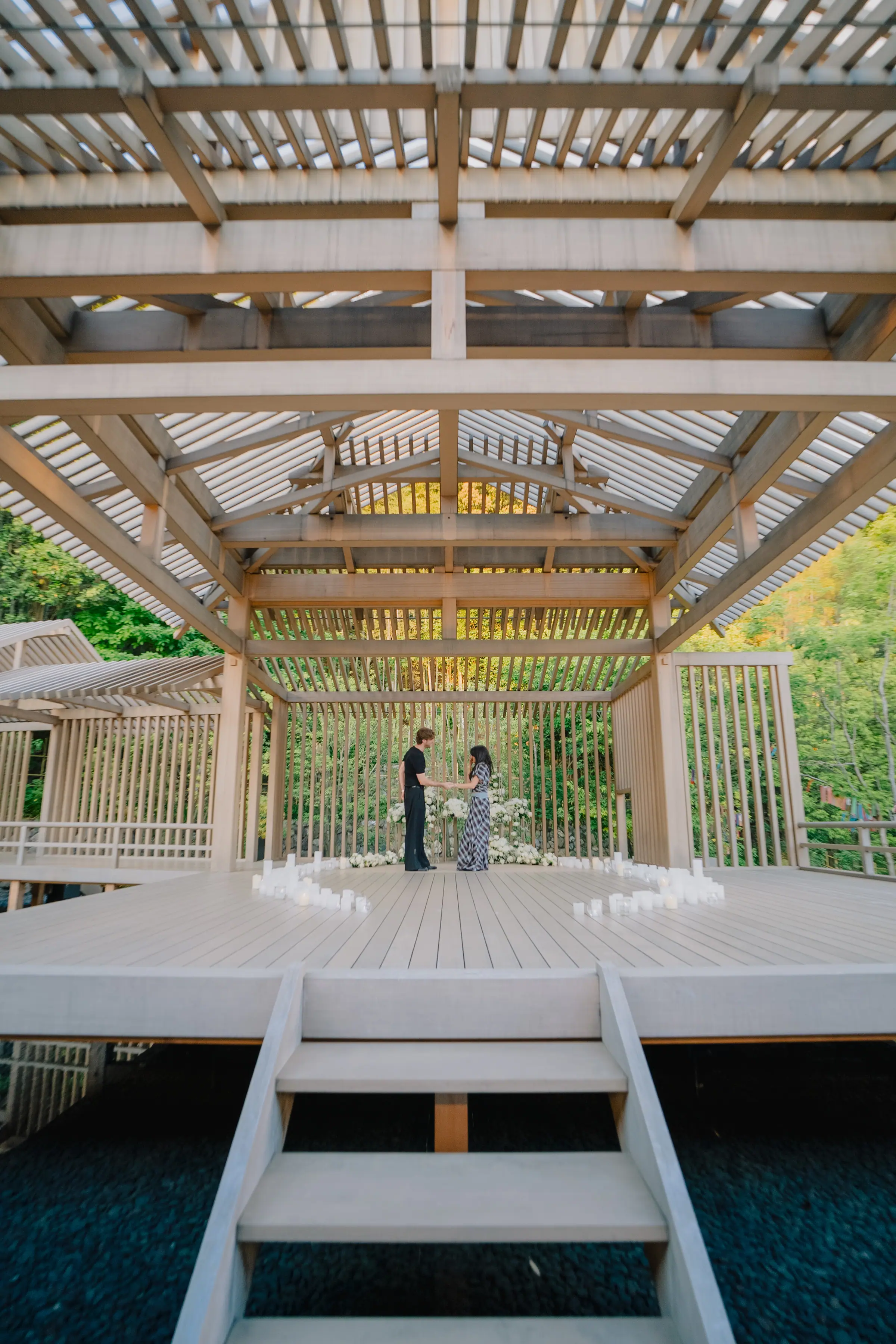 A couple standing together in a candlelit pavilion