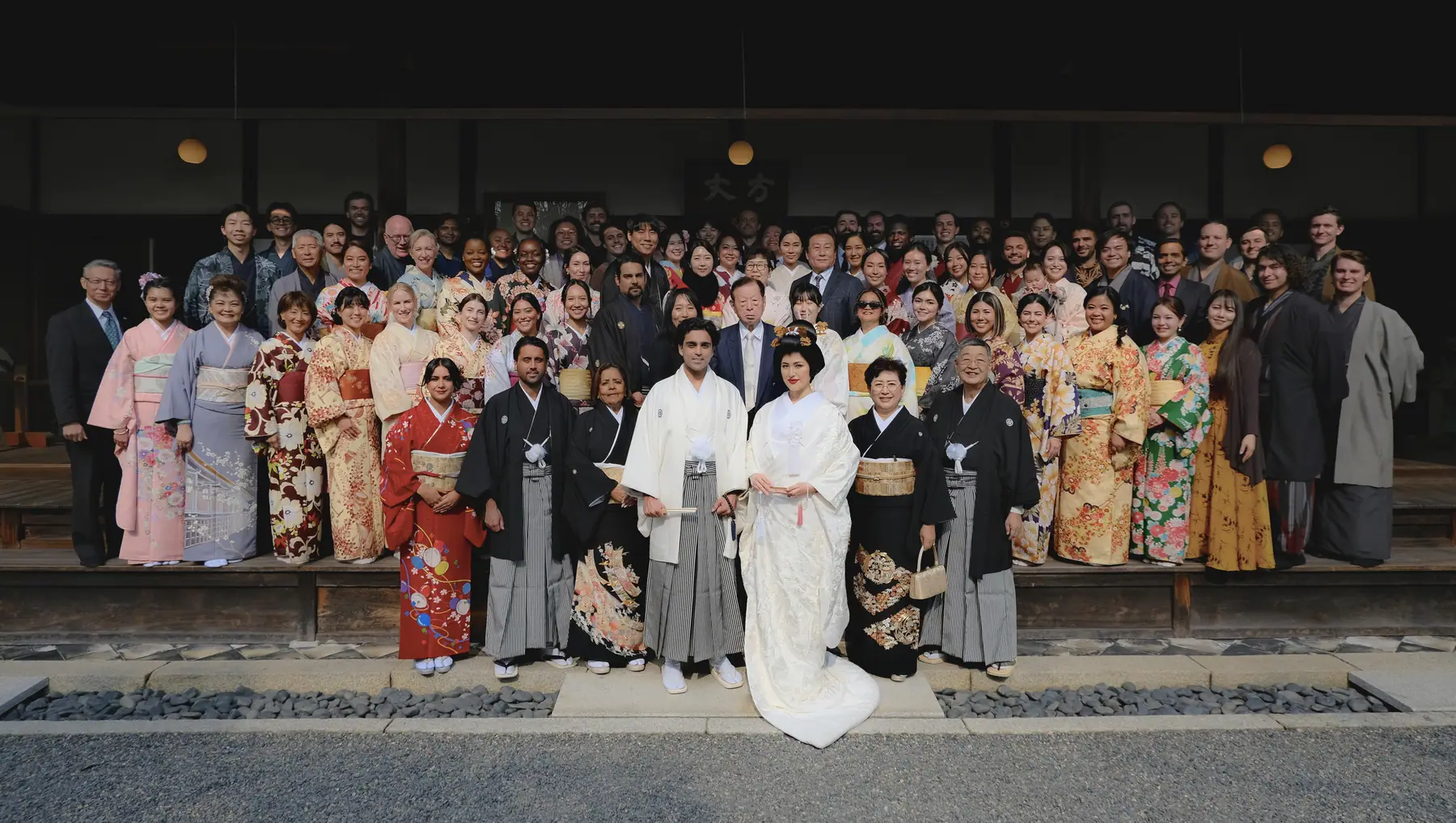 A full wedding party gathered outside a shrine in Tokyo