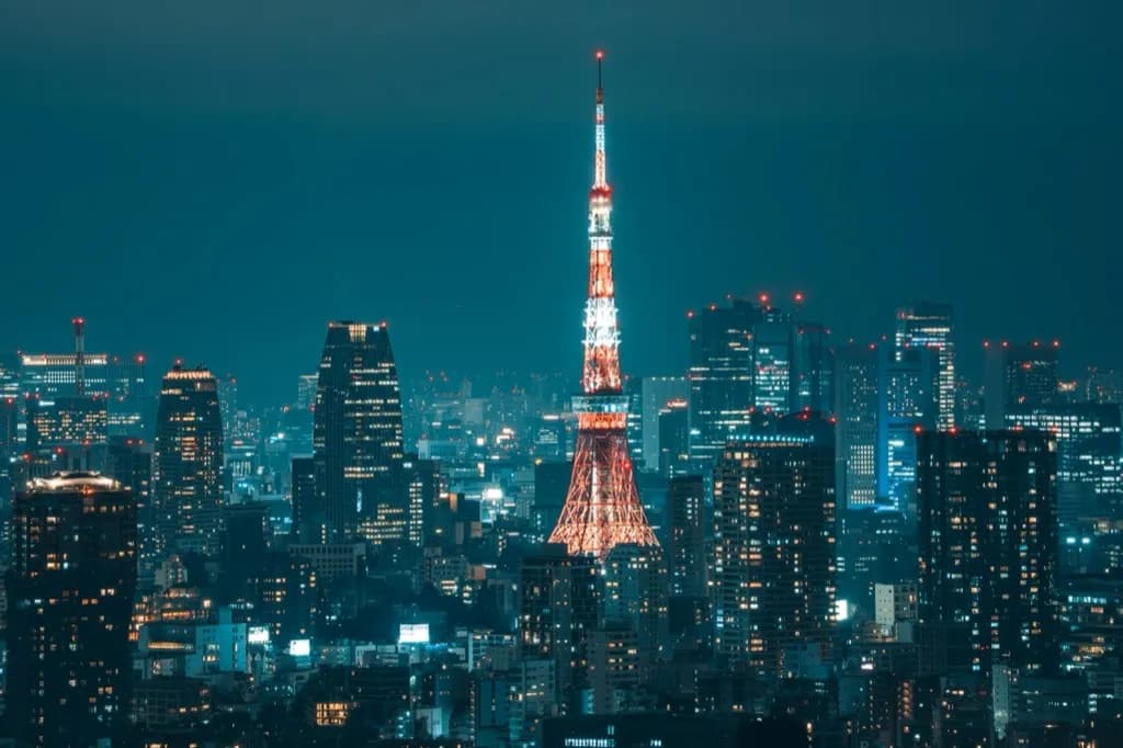 Tokyo skyline at night with Tokyo Tower lit up among the office towers